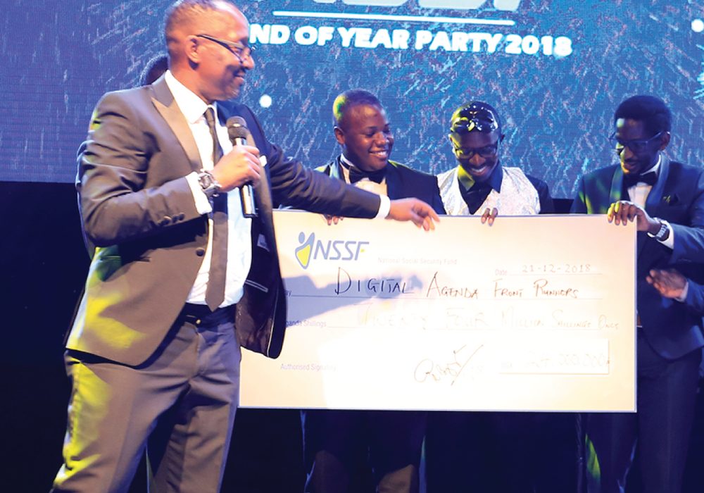 Cheque presentation on stage at the NSSF End of Year Party